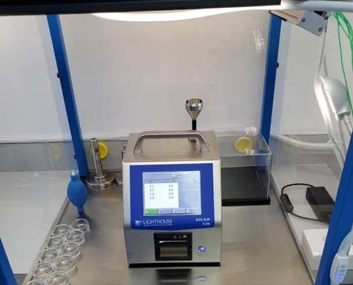 Lighthouse SOLAIR 3100 particle counter inside Tri-State Data Recovery's second ISO Class 4 certified flow hood, showing zero counts at 0.3, 0.5, 1.0 and 5.0 microns