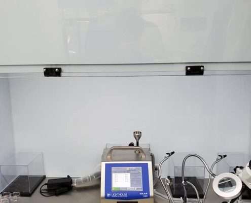 Lighthouse SOLAIR 3100 particle counter running inside a Tri-State Data Recovery ISO Class 4 flow hood alongside recovery tooling