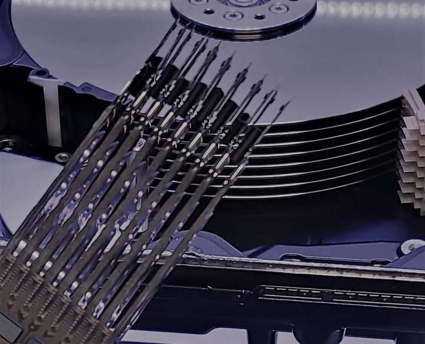 A 12TB helium-sealed hard drive opened in the clean room with its sixteen-head stack withdrawn from the platters