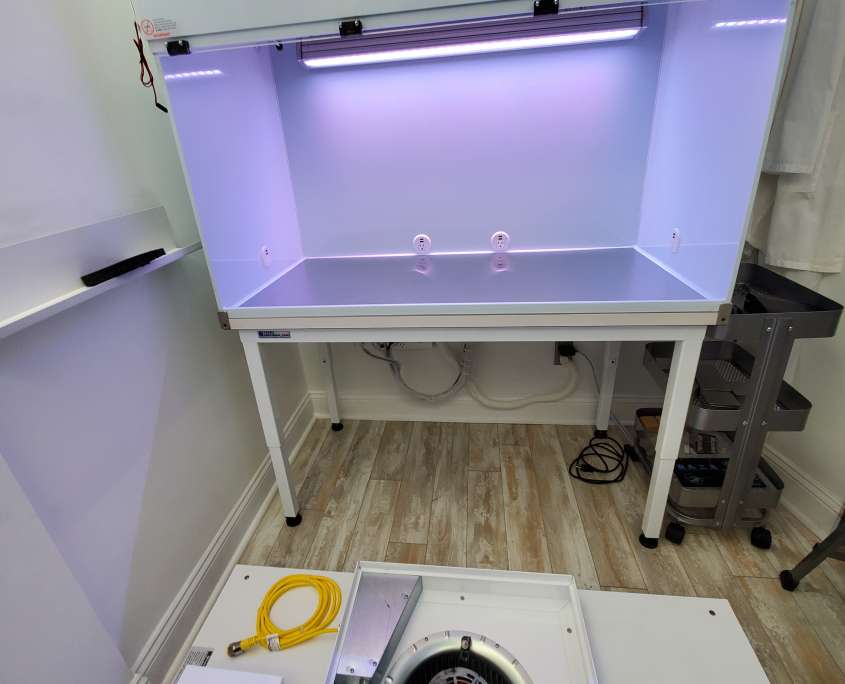 Tri-State Data Recovery custom laminar flow hood during installation, with the blower and filter housing unmounted on the floor before final assembly