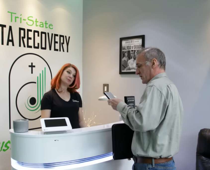 A client hand delivering a failed drive at the Tri-State Data Recovery office in King of Prussia, Pennsylvania